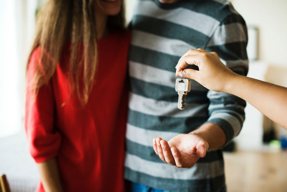 People receiving keys to new home