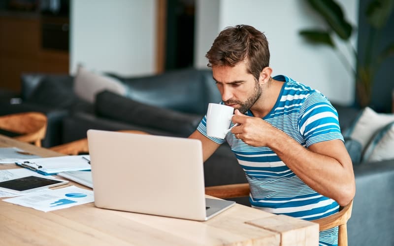 Man on laptop looking at his early repayment charge